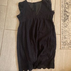Black romper dress with pockets.